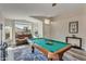 Open game room with a pool table, a sitting area, and beautiful natural light from large windows at 7140 E Juanita Ave, Mesa, AZ 85209