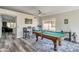 Bright game room features a pool table with new floors and adjacent bar table with chairs at 7140 E Juanita Ave, Mesa, AZ 85209