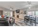Spacious living area with a cozy fireplace, comfortable seating, and dining table set at 7140 E Juanita Ave, Mesa, AZ 85209