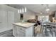 Open-concept living space with hardwood floors, ample natural light, and modern lighting fixtures at 7140 E Juanita Ave, Mesa, AZ 85209