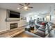 Comfortable living room with fireplace, hardwood floors, and a large leather sofa at 7140 E Juanita Ave, Mesa, AZ 85209