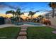 Inviting backyard featuring a pool, comfortable lounge chairs and lush landscaping at 7140 E Juanita Ave, Mesa, AZ 85209