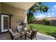 Inviting covered back patio with outdoor seating, grill, and views of the backyard at 7925 E Osage Ave, Mesa, AZ 85212