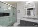 Stylish bathroom featuring a glass shower, gray vanity with sink, and marble tile at 7925 E Osage Ave, Mesa, AZ 85212