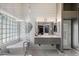 Elegant bathroom with double vanity, soaking tub, glass block window, and marble floors at 7925 E Osage Ave, Mesa, AZ 85212