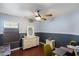 Bedroom with neutral tones and wood flooring features a dresser and a ceiling fan at 7925 E Osage Ave, Mesa, AZ 85212