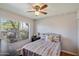Cozy bedroom with large window providing ample natural light and view of outside at 7925 E Osage Ave, Mesa, AZ 85212