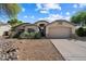 Inviting single-story home featuring an attached two-car garage and desert-style landscaping at 7925 E Osage Ave, Mesa, AZ 85212