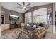 Comfortable living room boasting a ceiling fan, entertainment center with fireplace and large sectional sofa at 7925 E Osage Ave, Mesa, AZ 85212