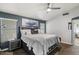 Spacious main bedroom with wood floors, ceiling fan, and ensuite bathroom at 7925 E Osage Ave, Mesa, AZ 85212