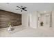 Spacious bedroom with wood accent wall, neutral carpet, and modern ceiling fan at 794 W Leatherwood Ave, Queen Creek, AZ 85140