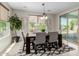 Dining room with a wooden table, six chairs, and sliding doors to the backyard at 794 W Leatherwood Ave, Queen Creek, AZ 85140