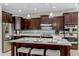 Kitchen featuring a spacious island with seating, stainless steel appliances, and modern lighting at 794 W Leatherwood Ave, Queen Creek, AZ 85140