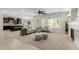 Open concept living room with neutral furniture, fireplace, bright windows, and kitchen access at 794 W Leatherwood Ave, Queen Creek, AZ 85140