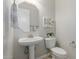 Well-lit powder room with pedestal sink, decorative mirror, and modern fixtures at 794 W Leatherwood Ave, Queen Creek, AZ 85140