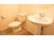 Bathroom with pedestal sink and toilet with tile flooring at 9025 W Crown King Rd, Tolleson, AZ 85353