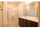 Bathroom featuring a large vanity with double sinks and a glass-enclosed shower at 9025 W Crown King Rd, Tolleson, AZ 85353