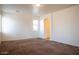 Bedroom with neutral carpeting, bright natural light, and doorway at 9025 W Crown King Rd, Tolleson, AZ 85353