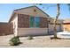 Charming home featuring stone facade and a well-maintained desert landscaped front yard at 9025 W Crown King Rd, Tolleson, AZ 85353