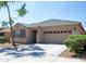 Inviting single-story home featuring a two-car garage, stone accents, and landscaped front yard at 9025 W Crown King Rd, Tolleson, AZ 85353