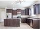 Spacious kitchen featuring stainless steel appliances, dark cabinetry, and a center island at 9025 W Crown King Rd, Tolleson, AZ 85353
