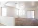 Bright living room features neutral carpet, lots of natural light, and leads to outdoor patio at 9025 W Crown King Rd, Tolleson, AZ 85353