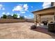 Spacious dirt backyard with a covered patio area perfect for outdoor entertaining at 973 E Corral St, Avondale, AZ 85323