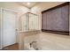 Clean bathroom featuring a tub, glass shower, door to the bathroom, and woven blinds at 973 E Corral St, Avondale, AZ 85323