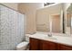 Well-lit bathroom featuring a vanity with a sink and a shower with a decorative curtain at 973 E Corral St, Avondale, AZ 85323