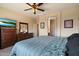 Bright bedroom with carpet flooring, large dresser, and a connecting door to the ensuite at 973 E Corral St, Avondale, AZ 85323