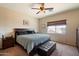 Comfortable bedroom with a large bed, dark wood furniture, ceiling fan, and ample natural light at 973 E Corral St, Avondale, AZ 85323