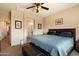 Spacious bedroom featuring a large bed, ceiling fan, and an ensuite bathroom entrance at 973 E Corral St, Avondale, AZ 85323