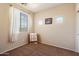 A small, minimal bedroom, featuring carpet, a twin bed, and natural light at 973 E Corral St, Avondale, AZ 85323