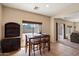 Bright dining area with a dark wood table set and large window overlooking the backyard at 973 E Corral St, Avondale, AZ 85323