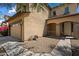 Exterior shot of the house showing the tan stucco, garage, and covered porch with stone supports at 973 E Corral St, Avondale, AZ 85323
