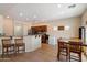 Kitchen with tile flooring, wooden cabinets, stainless steel appliances and dining table at 973 E Corral St, Avondale, AZ 85323