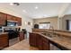 Kitchen featuring stainless steel appliances, wood cabinets, tile flooring and a breakfast bar at 973 E Corral St, Avondale, AZ 85323