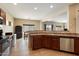 Spacious kitchen features stainless steel appliances, tile flooring, and an open layout to the dining area at 973 E Corral St, Avondale, AZ 85323