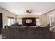 A spacious living room with a sectional sofa, large TV, ceiling fan and staircase to the second floor at 973 E Corral St, Avondale, AZ 85323