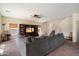 Living room featuring a large sectional sofa, ceiling fan and entertainment center with a flat screen TV at 973 E Corral St, Avondale, AZ 85323
