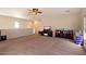 Spacious living room featuring neutral walls, carpet flooring, ceiling fan, and natural light at 973 E Corral St, Avondale, AZ 85323