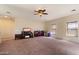 Spacious living room featuring neutral walls, carpet flooring, ceiling fan, and natural light at 973 E Corral St, Avondale, AZ 85323