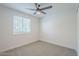 Neutral bedroom with a ceiling fan and window at 1021 S Almar Cir, Mesa, AZ 85204