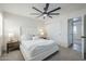 Bedroom with a ceiling fan, closet, and a window overlooking the yard, providing light and ventilation at 1021 S Almar Cir, Mesa, AZ 85204