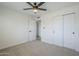 Bedroom featuring neutral carpet, a ceiling fan, a closet, and a bright window for natural light and ventilation at 1021 S Almar Cir, Mesa, AZ 85204