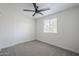 Bright, minimalist bedroom with neutral colors and a ceiling fan at 1021 S Almar Cir, Mesa, AZ 85204