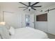 Bright bedroom featuring a ceiling fan, closet, and barn door leading to a comfortable living space at 1021 S Almar Cir, Mesa, AZ 85204