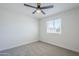 Simple bedroom with neutral carpet, ceiling fan, and natural light coming through the window, creating a cozy space at 1021 S Almar Cir, Mesa, AZ 85204