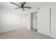 Clean bedroom with a ceiling fan, closet, and neutral carpet at 1021 S Almar Cir, Mesa, AZ 85204