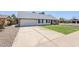 View of the home showcasing its traditional architecture and concrete driveway at 1021 S Almar Cir, Mesa, AZ 85204